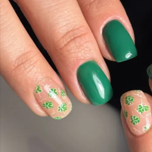 Short square gel nails in glossy green with clover accent art