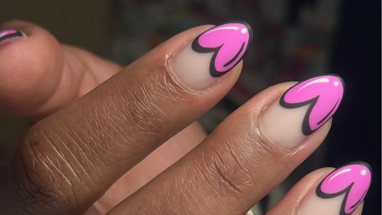 Nude nails with bold pink heart tips