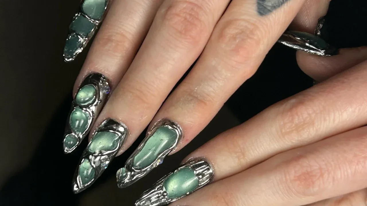 Sage green chrome nails with silver 3D accents