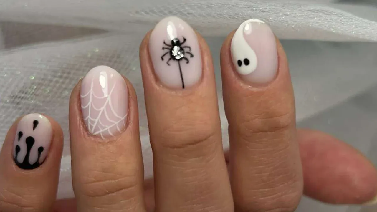 Milky white nails with spider web and ghost art