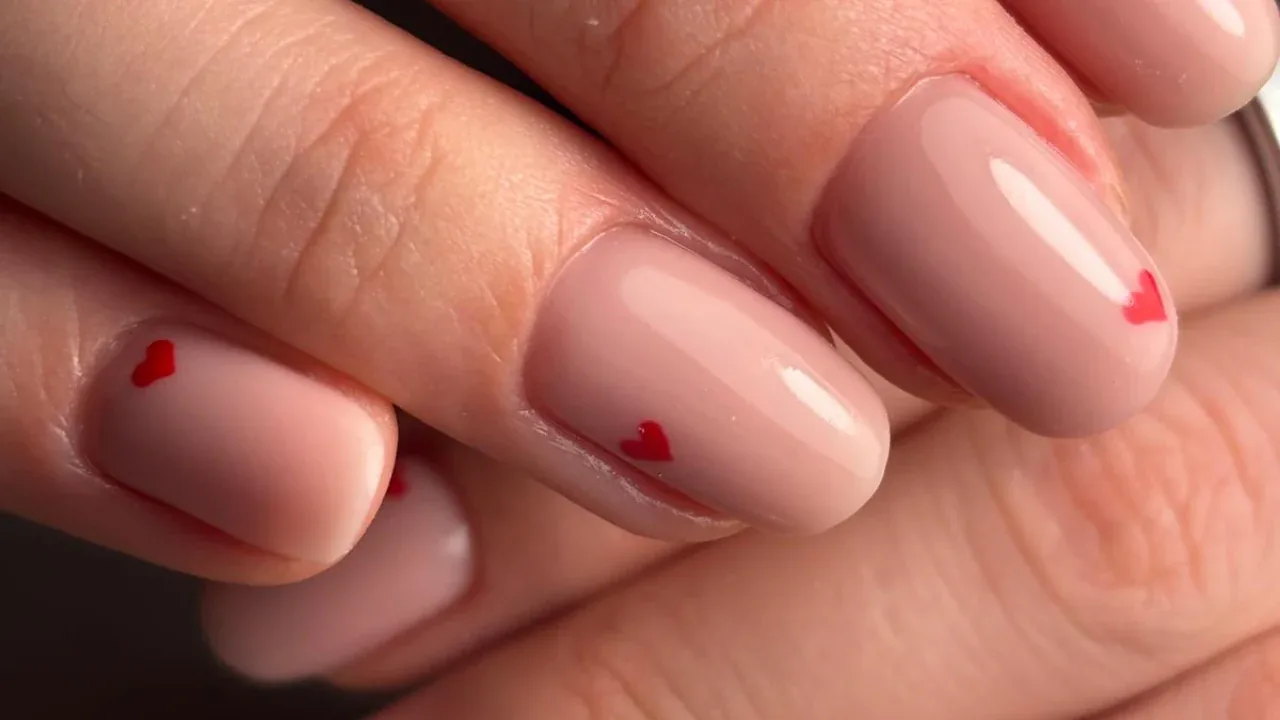 Nude nails with tiny red hearts