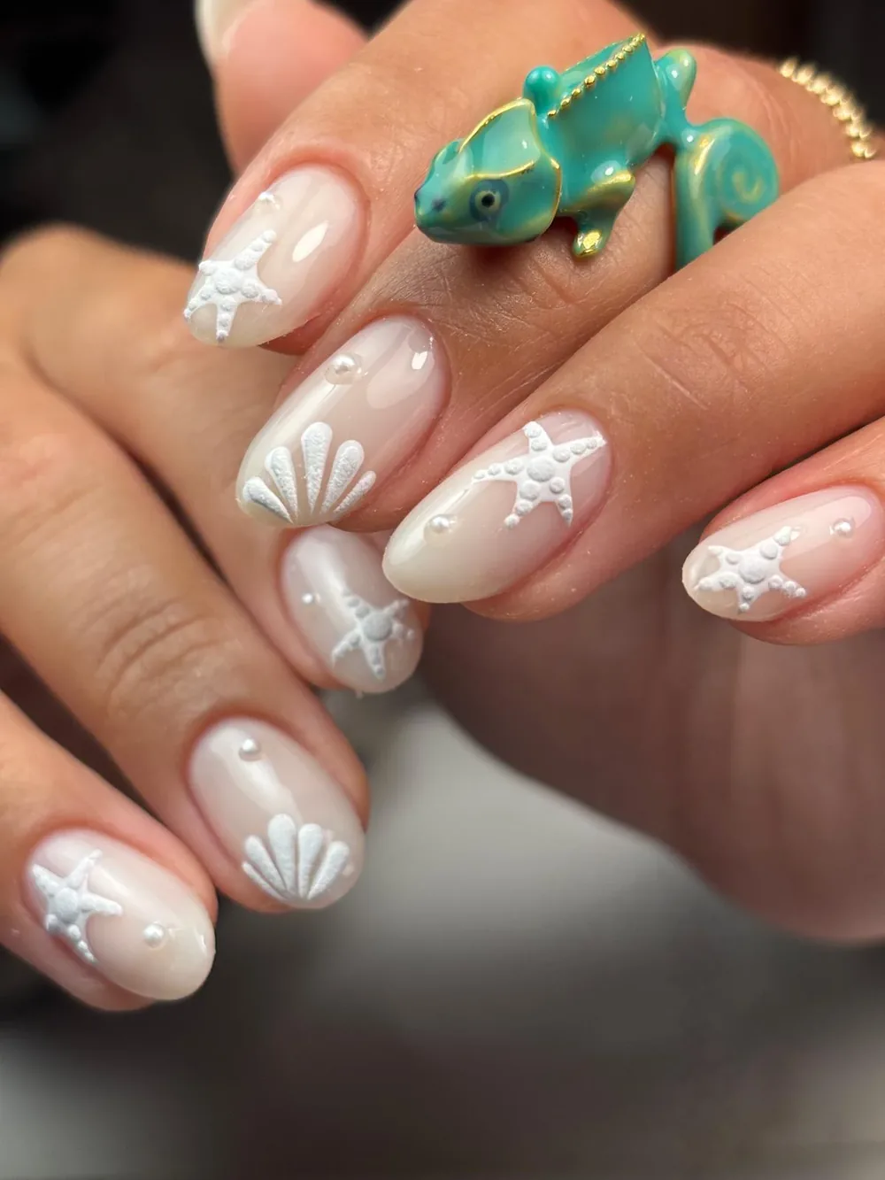 Milky nails with white starfish and seashell art
