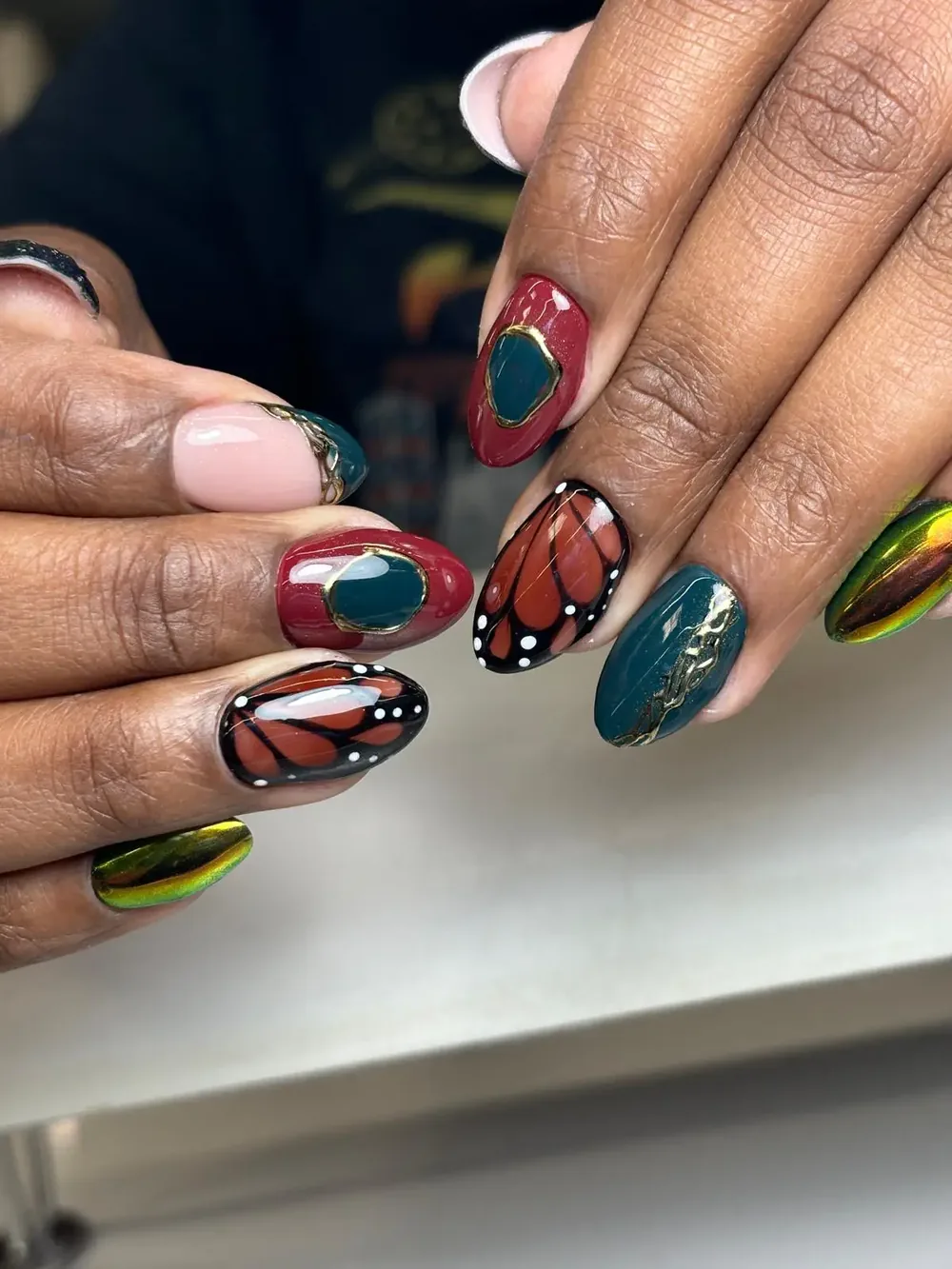 Monarch butterfly and teal mismatched nails