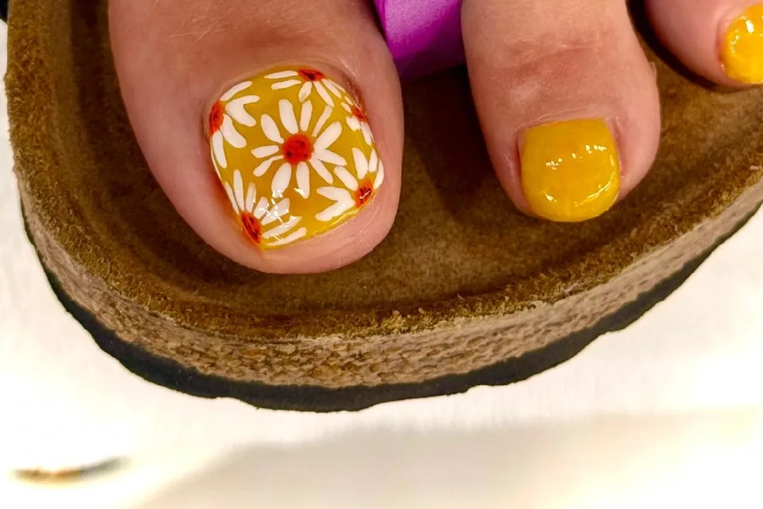 Pedicure with yellow floral nail art